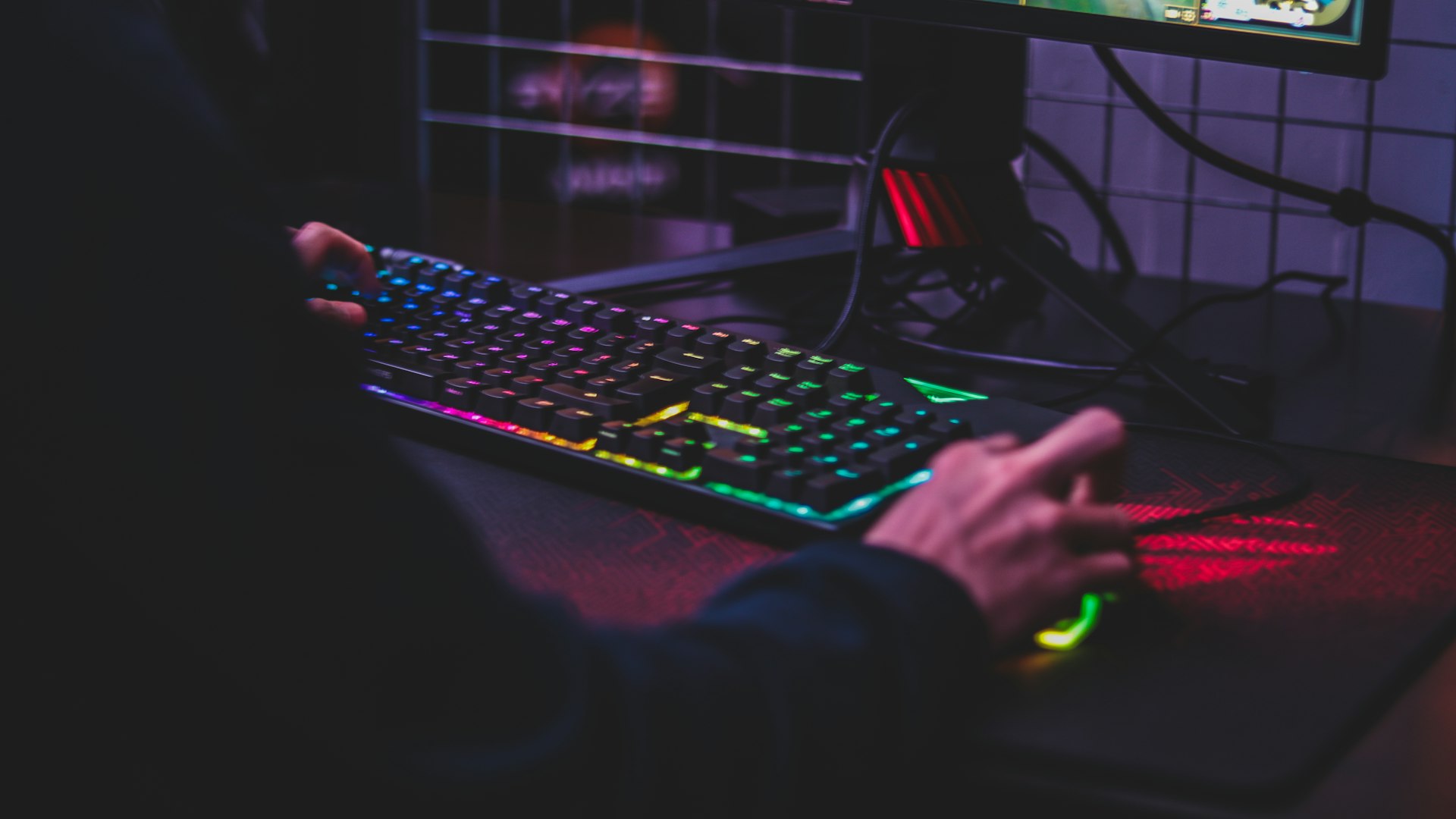 Gamers competing at glowing battle stations inside the Pixel Battle Odyssey arena